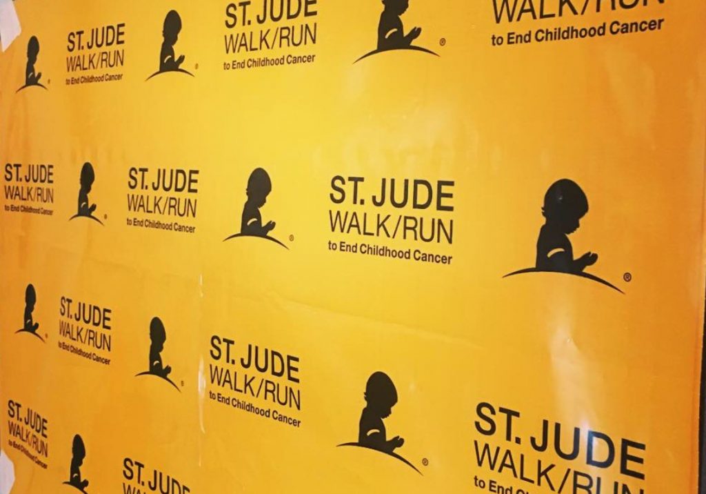 Community 8 A yellow banner displays the St. Jude Walk/Run logo, supporting childhood cancer research and treatment, potentially reflecting the values of a Las Vegas personal injury law firm.
