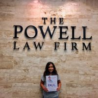 Girl and The Paul Powell Law Firm Sign