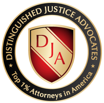 A gold badge with the text "Distinguished Justice Advocates Top 1% Attorneys in America", with a red and gold shield in the middle, suitable for a personal injury law firm in Las Vegas.