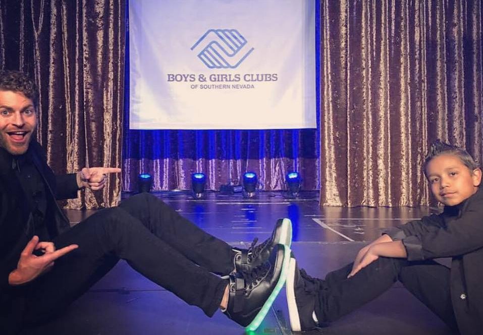 Law firm representative and child at a Boys & Girls Club of Southern Nevada event, symbolizing the firm's commitment to the community, with focus on personal injury and child welfare.