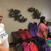 Backpacks and volunteers back to school giveaway
