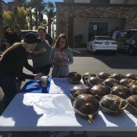 Participants approach turkeys at 2017 Thanksgiving table