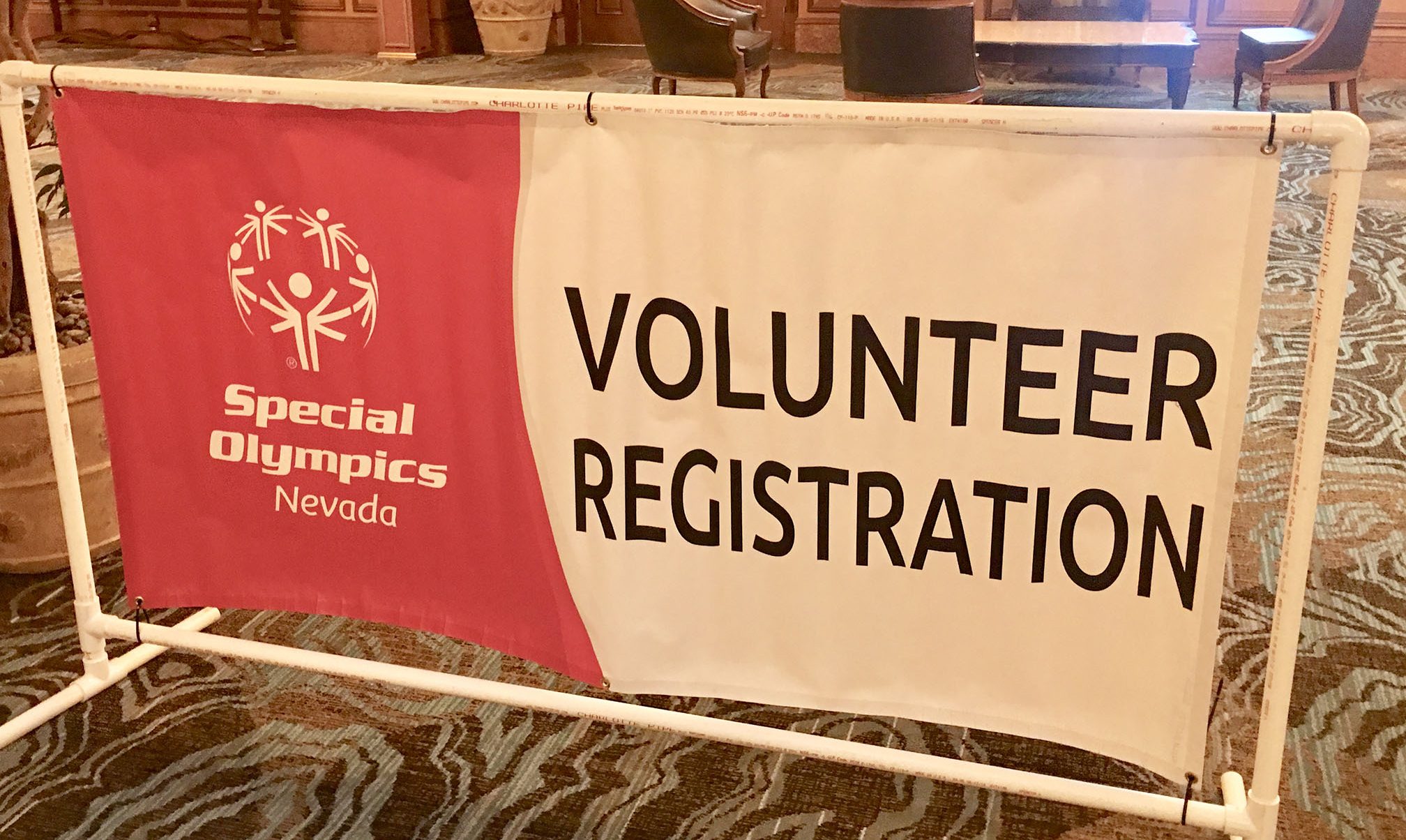 Close-up of a Special Olympics Nevada volunteer registration banner, symbolizing community involvement and the Las Vegas values of supporting those who may be vulnerable, reflecting the compassion of a dedicated personal injury law firm.