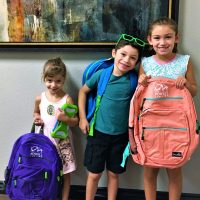 Three children and backpacks 2017 back to school giveaway