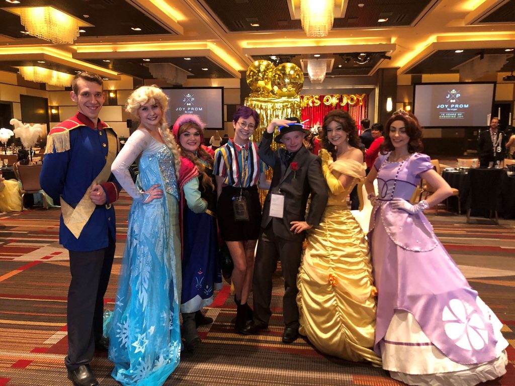 Community 3 A group of joyful attendees in Las Vegas at the Joy Prom event, dressed in vibrant costumes, potentially injured through negligence, and seeking justice in personal injury claims.