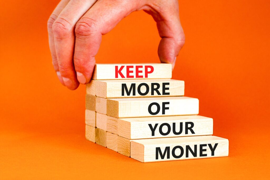Las Vegas Legal Battles Are Fought in Shades of Gray 2 A hand placing a block labeled "KEEP" atop a stack of blocks that read "MORE OF YOUR MONEY," symbolizing how a personal injury law firm can help clients retain a larger portion of their settlement after an accident in Las Vegas.