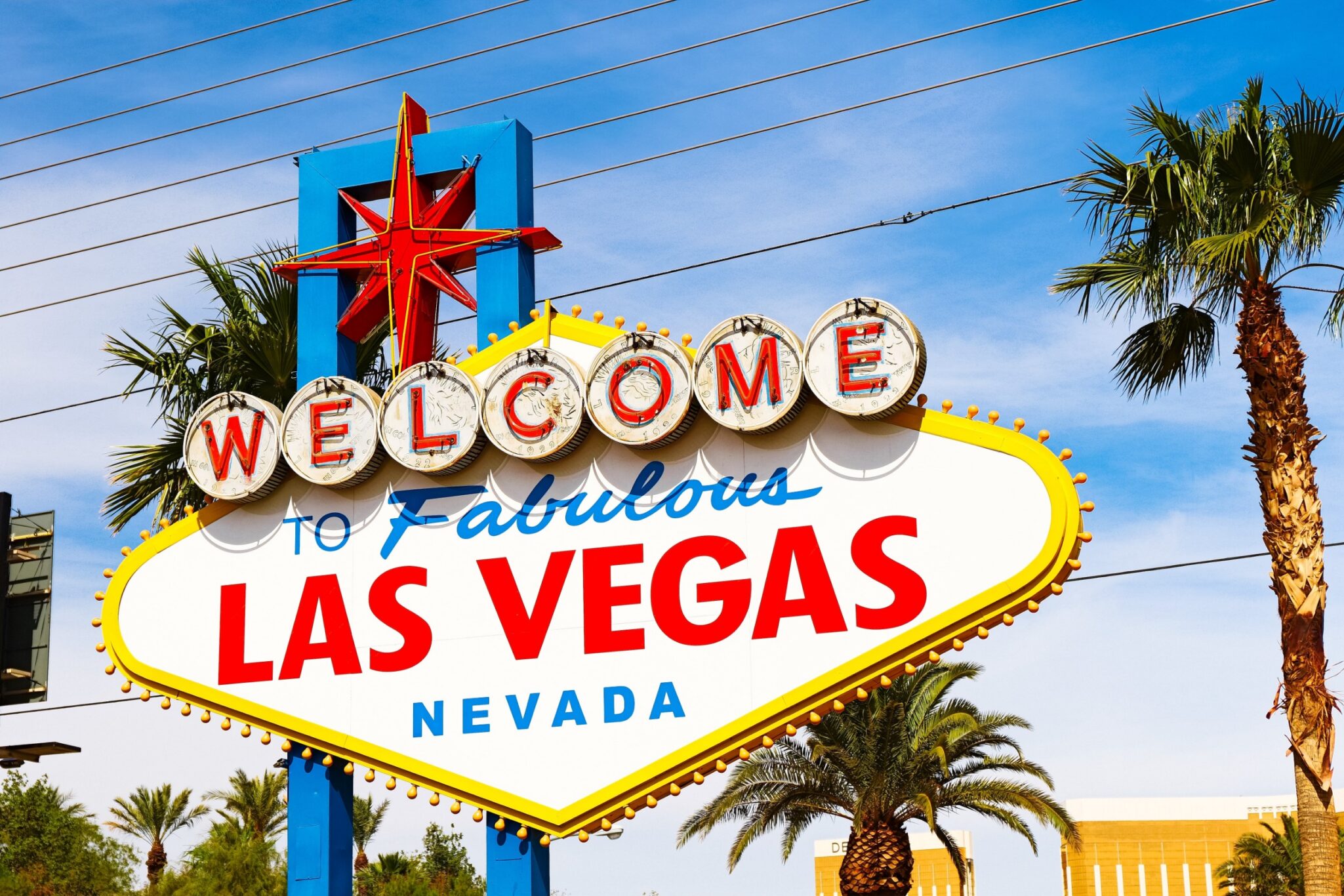 Welcome to Fabulous Las Vegas sign under a bright blue sky and palm trees, representing a personal injury law firm serving Las Vegas, Nevada.