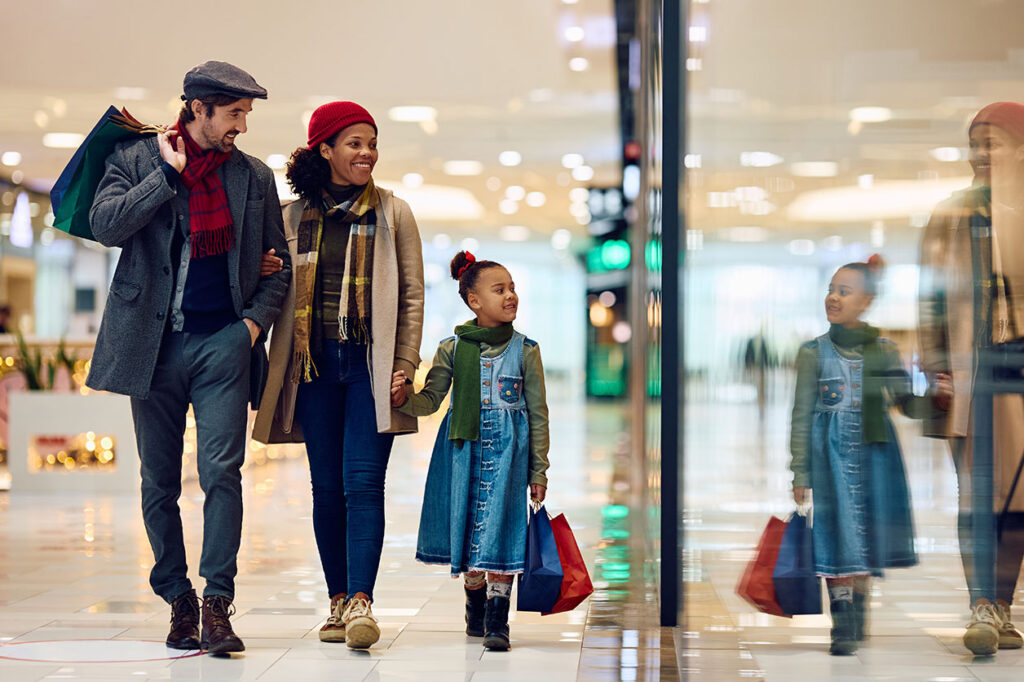 A family walks through a brightly lit Las Vegas shopping mall, emphasizing the importance of safety during outings, representing a potential personal injury scenario due to negligence.