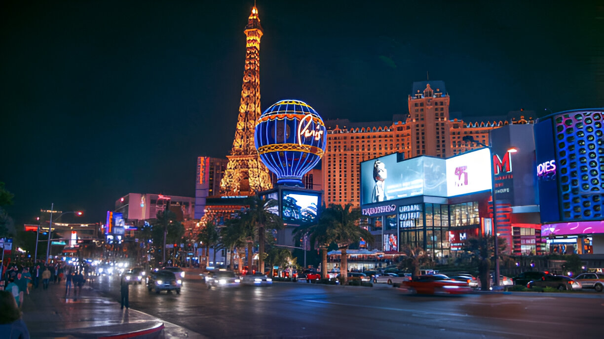 Night view of the Las Vegas Strip with illuminated casinos, hotels, traffic, and pedestrians, representing the city's vibrant and potentially hazardous environment where personal injury accidents can occur.