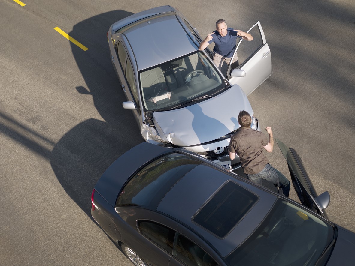 High-angle shot of two men arguing after a car accident, useful for a personal injury law firm in Las Vegas.