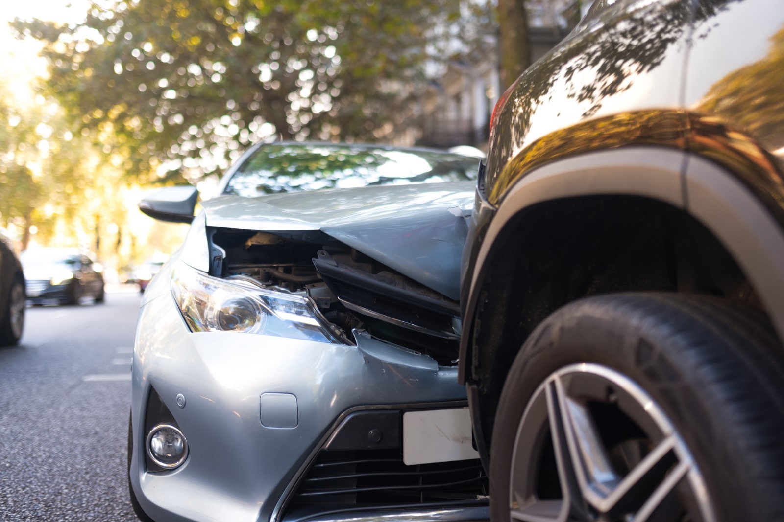 Close-up shot of two cars after a collision, emphasizing the front-end damage, suitable for a Las Vegas personal injury law firm to illustrate the consequences of car accidents.