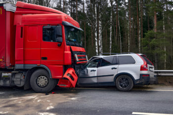 Image shows a red semi-truck having collided with a silver SUV on a rural road, representing potential legal cases for a personal injury law firm.