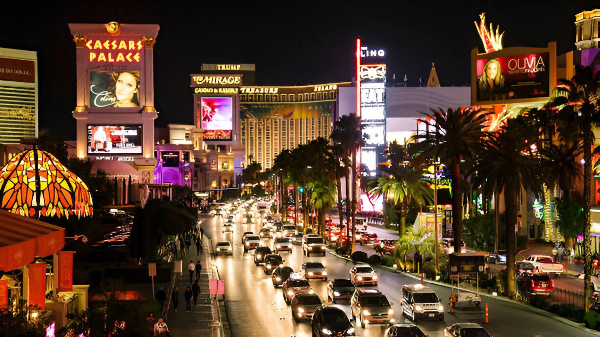Nighttime view of the Las Vegas Strip, featuring casinos like Caesar's Palace and heavy traffic, symbolizing the potential for personal injury accidents.